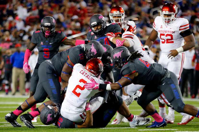 Houston Cougars running back Duke Catalon (2) is swarmed by the Southern Methodist Mustangs...