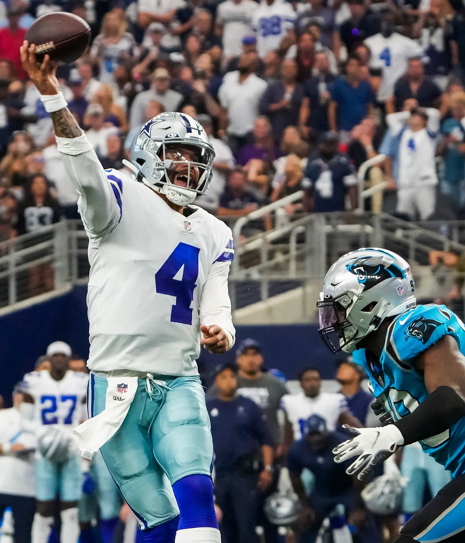 Dallas Cowboys quarterback Dak Prescott (4) throws a pass under pressure from Carolina...