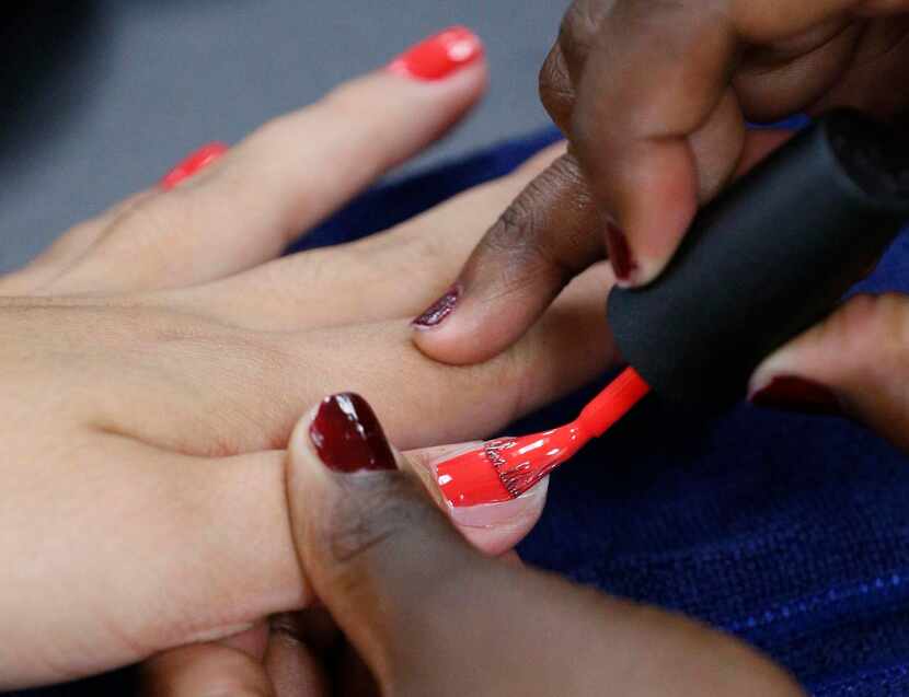 
Students give one another manicures in the new cosmetology lab. Nearly 50 students are...