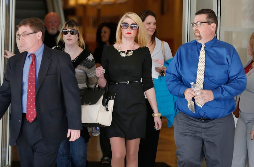 
Emily Ward, mother of victim Grace Ford, walked with friend Sonny Fox (right) from the...