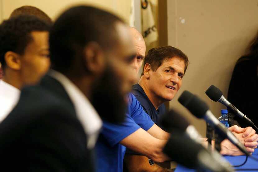 Mavericks owner Mark Cuban listens as Tim Hardaway Jr. answers questions during a press...