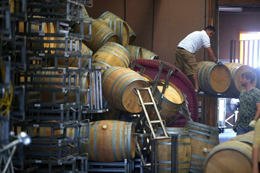 Workers move fallen wine barrels at Saintsbury Winery following a large earthquake in Napa,...