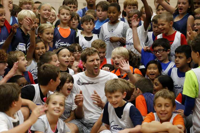 Dallas Mavericks basketball player Dirk Nowitzki gets the kids fired up to play a game of...