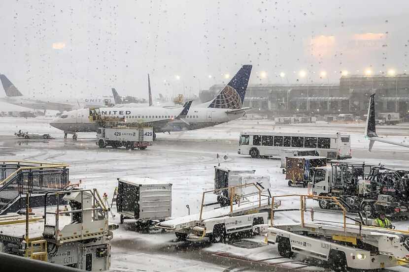 Snow falls on the United Terminal at O'Hare Airport in Chicago Monday morning, Nov. 11,...