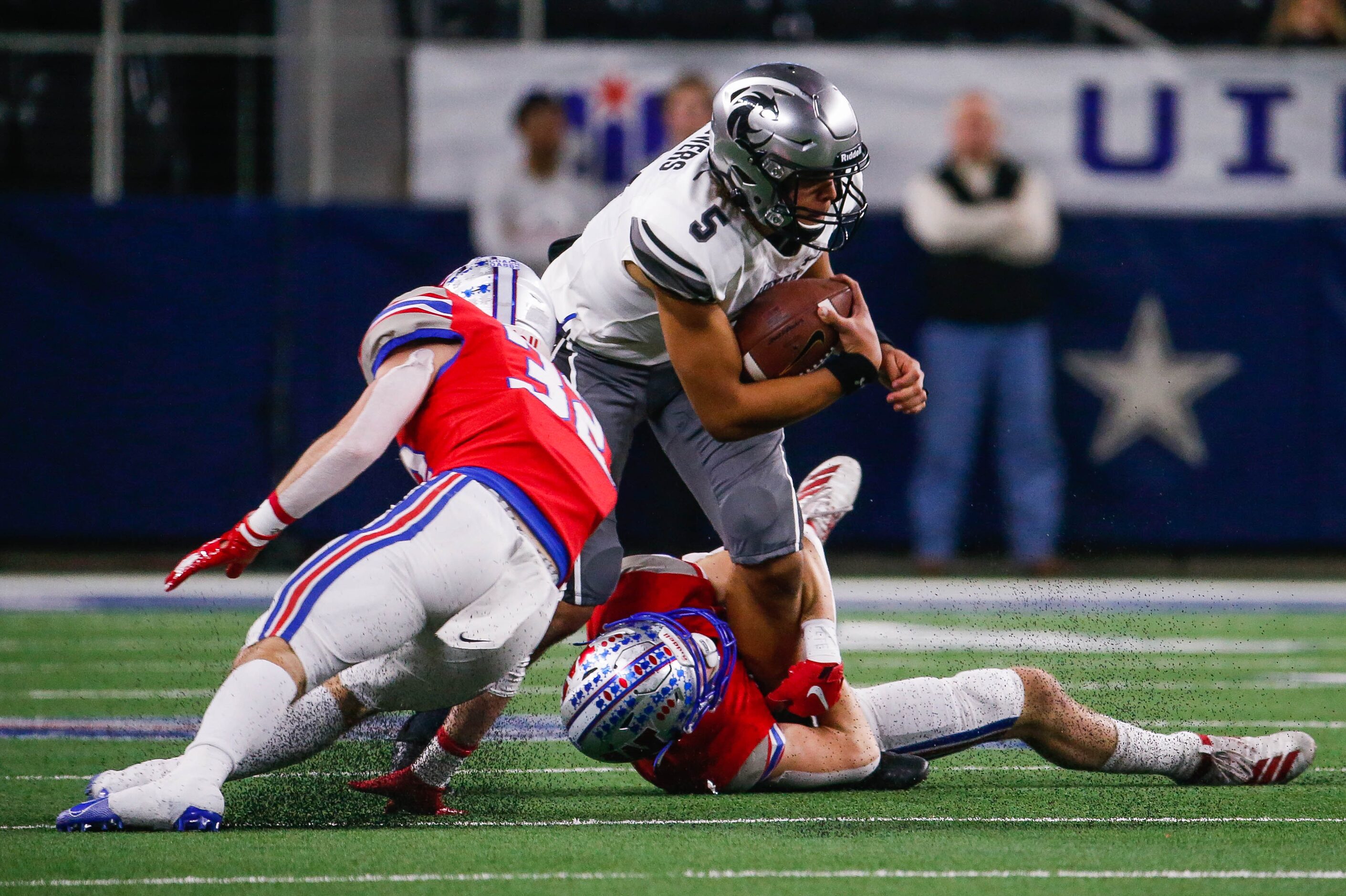 Denton Guyer's quarterback Eli Stowers (5) gets taken down by Austin Westlake's defense in...