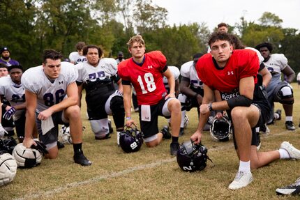 Stephen F. Austin Lumberjacks quarterback Trae Self (right) and other players join in a...