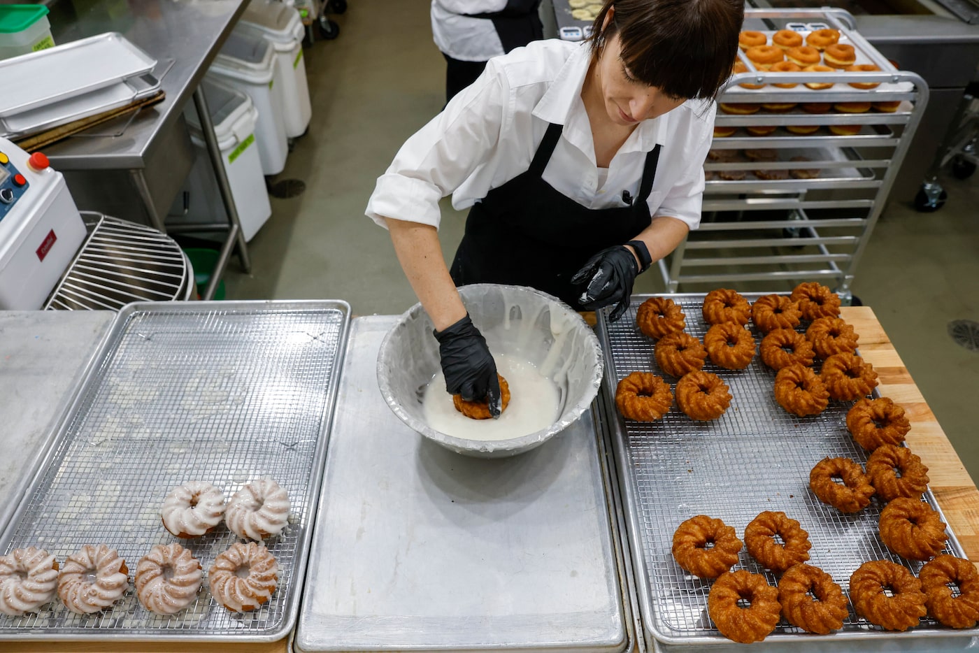 Owner Amy La Rue glazes doughnuts at La Rue Doughnuts in Trinity Groves, Wednesday, Aug. 28...