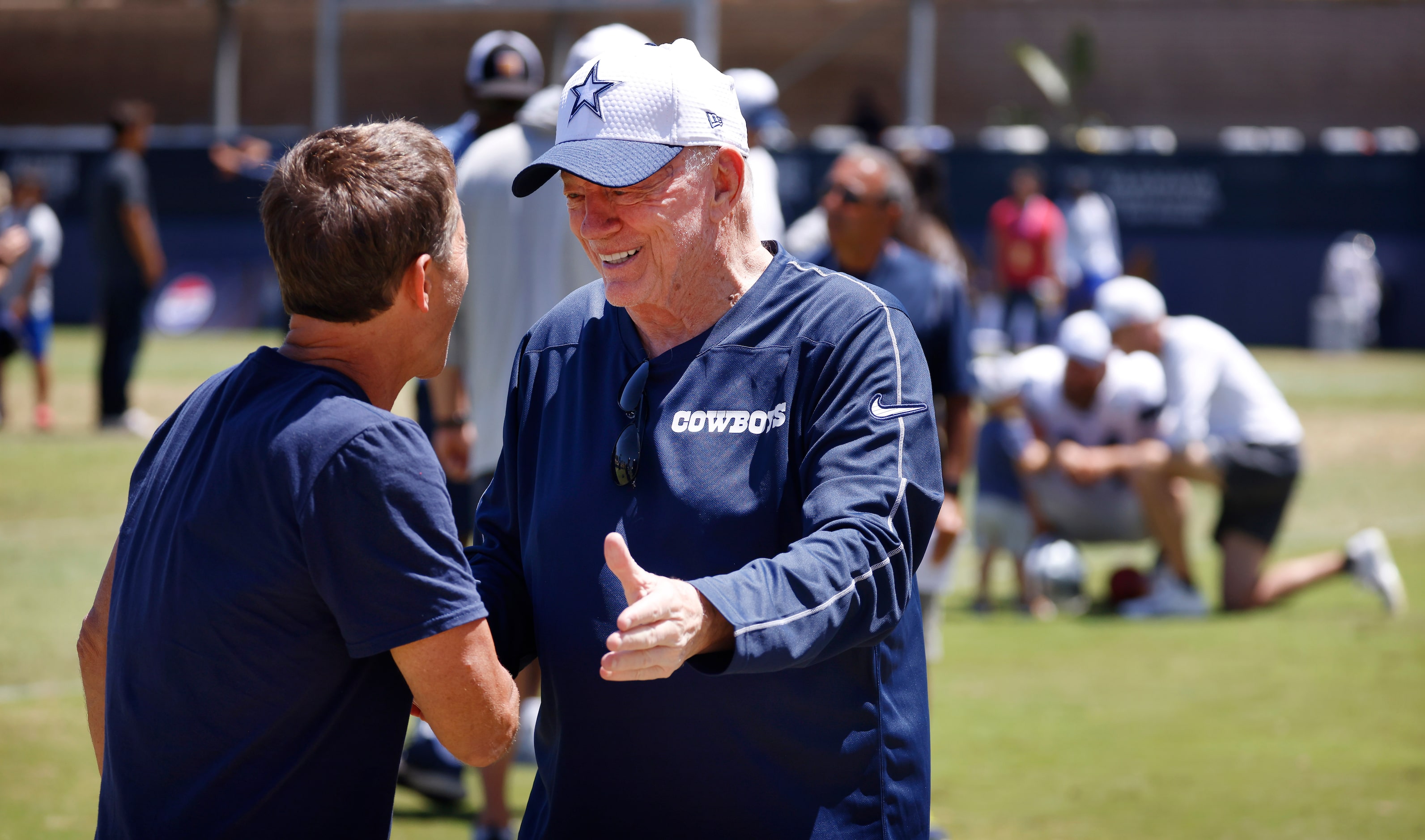 Dallas Cowboys owner Jerry Jones (right) visits with his special guest and former Arkansas...