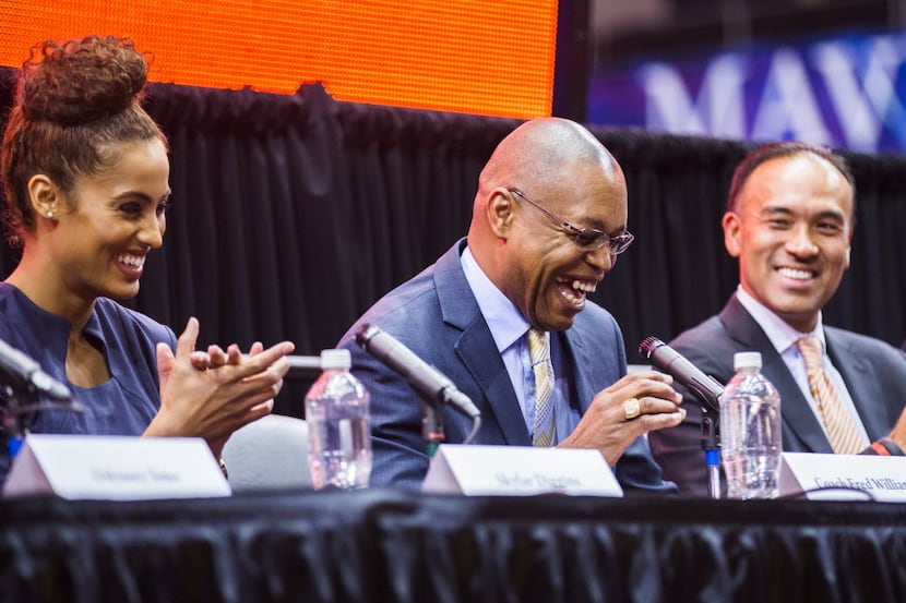 Coach Fred Williams (center) laughs during a press conference unveiling the name and logo of...