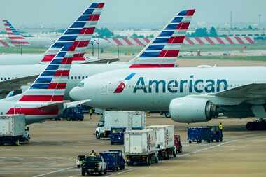 American Airlines planes are seen at the gates of Terminal C at DFW Airport on Tuesday, May...