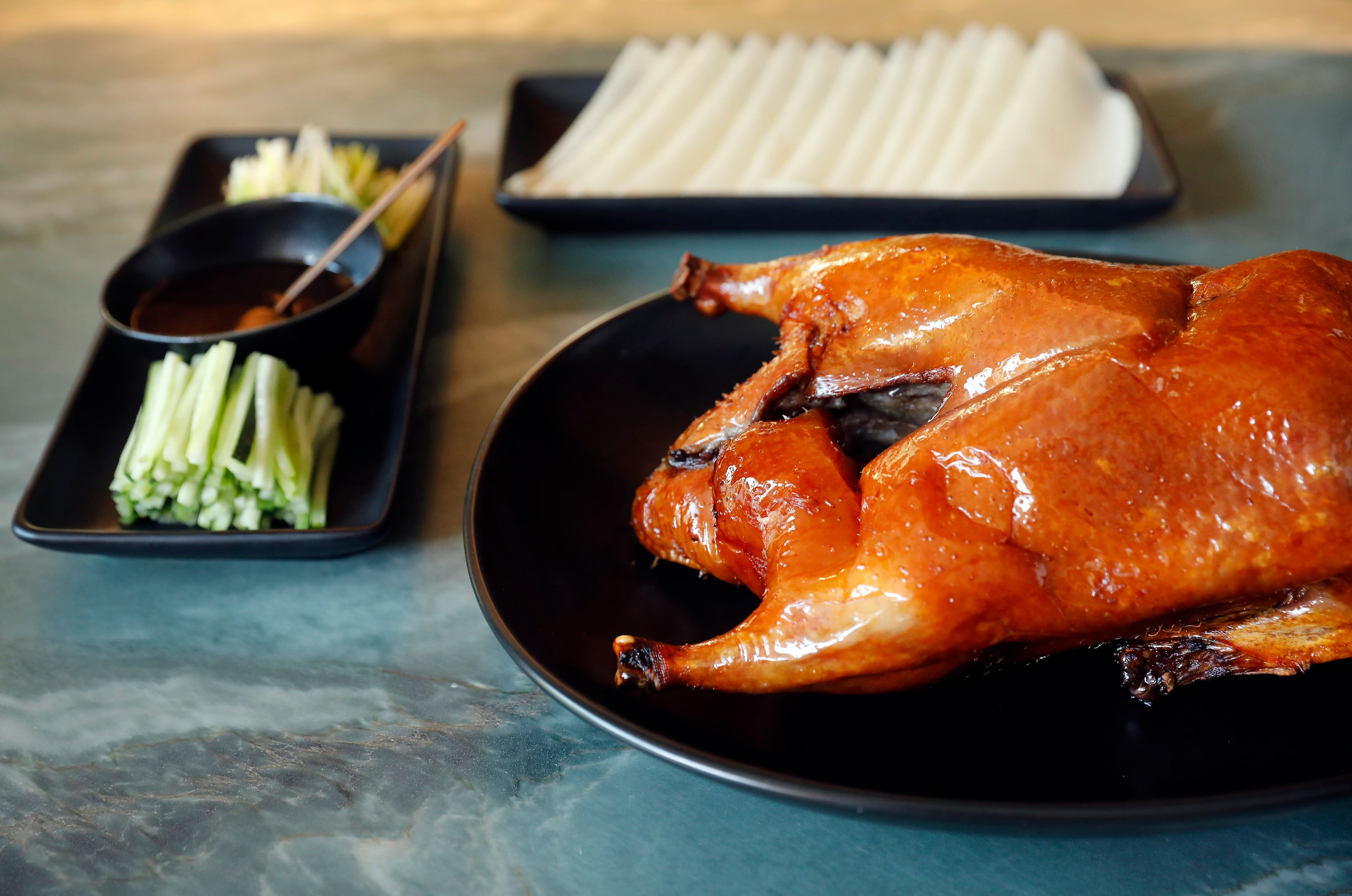 Peking duck with duck pancake, hoisin sauce, cucumber and green onion is on the menu at Le...