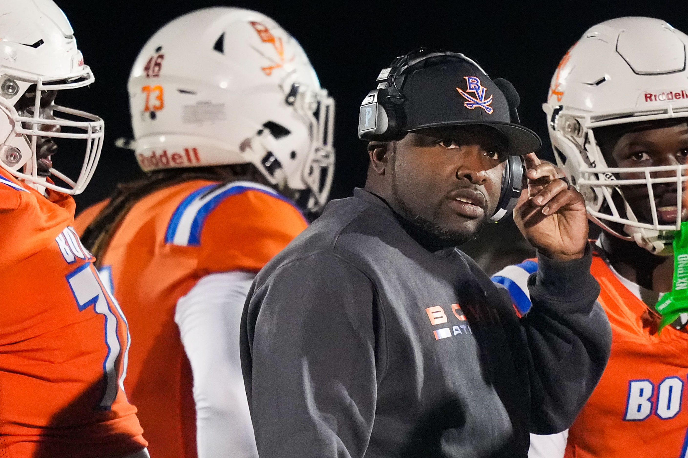 Arlington Bowie head coach Joseph Sam huddles with his players during the second half of a...