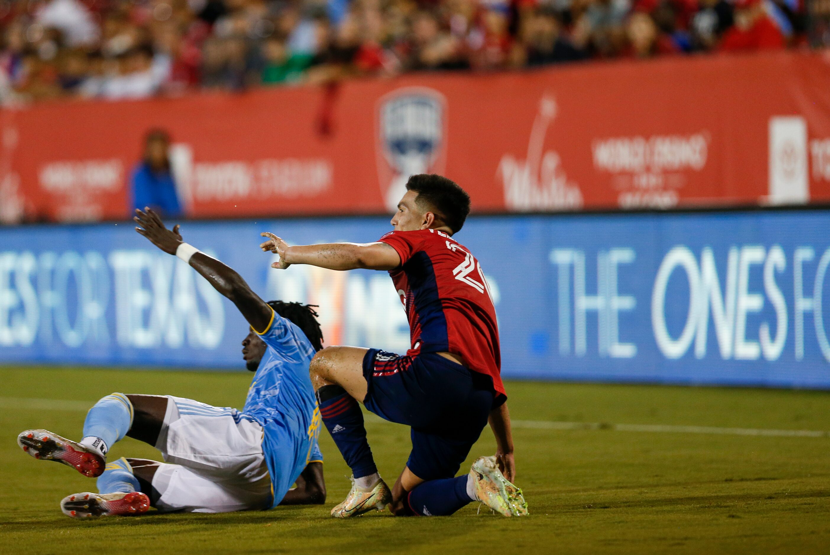 FC Dallas forward Alan Velasco (20) and Philadelphia Union defender Olivier Mbaizo (15) get...