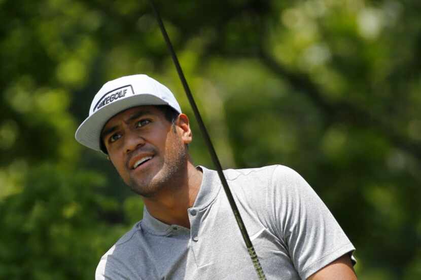 Golfer Tony Finau watches his drive off the No. 6 tee during the third round of the Dean and...
