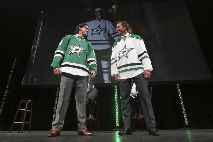 Former Dallas Stars Mike Modano, right, and current left wing Jamie Benn look at each other...