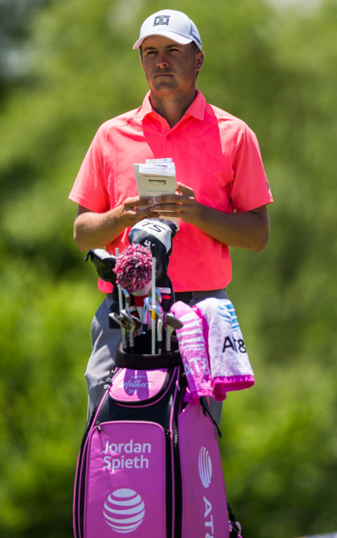 Jordan Spieth looks at his score card with his pink golf bag at hole 4 during round 4 of the...