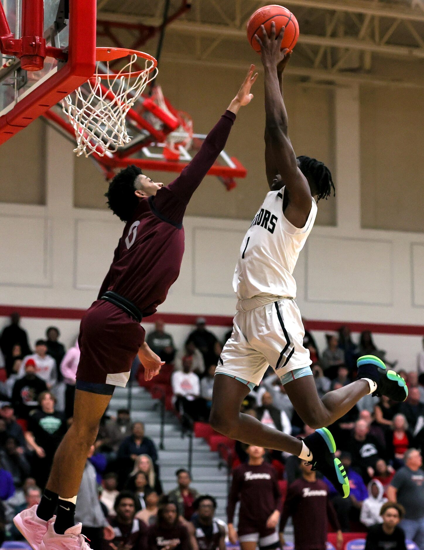 Arlington Martin guard Jeremiah Charles, (right) tries to go up for a dunk against...