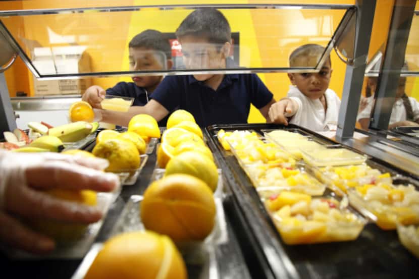 Students at Central Elementary school in Lewisville pick fruit from the cafeteria line. The...