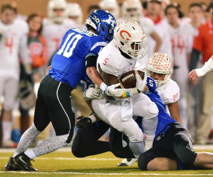 Krum senior linebacker Christian Martinez (10) and junior defensive end Raymond Barrinton...