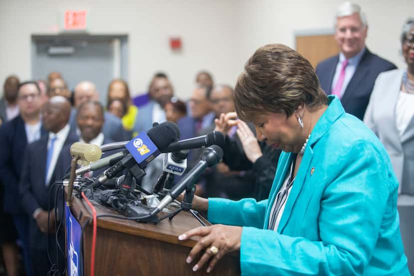 U.S. Rep. Eddie Bernice Johnson bows her head as she thanks supporters for voting for her as...