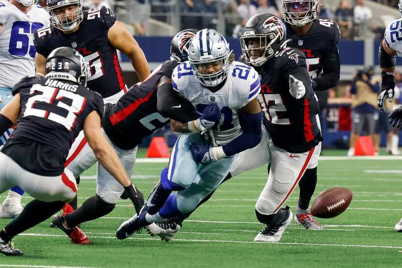Atlanta Falcons safety Richie Grant (27) forces a fumble from Dallas Cowboys running back...