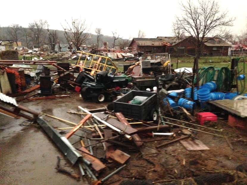Debris litters the area after a storm swept through the area and damaged homes in Sand...