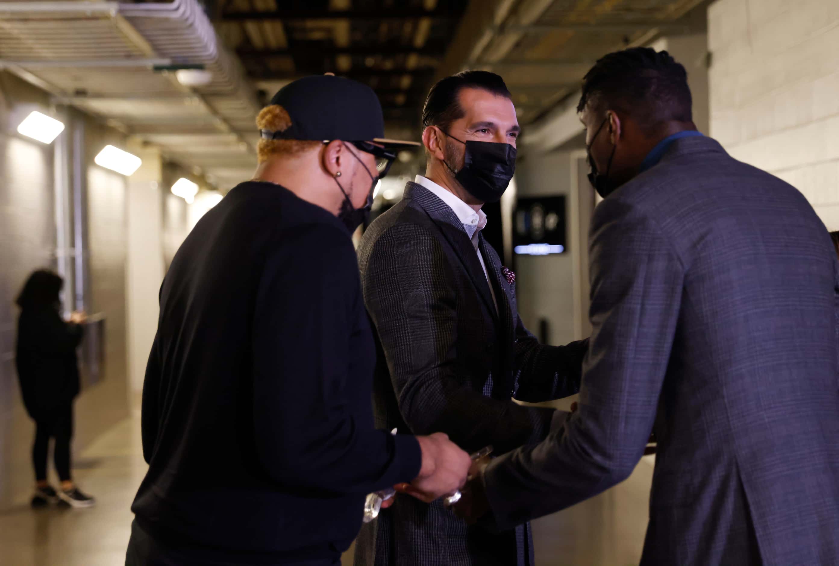 Former Dallas Mavericks players Shawn Marion, Peja Stojakovic, and Ian Mahinmi greet each...