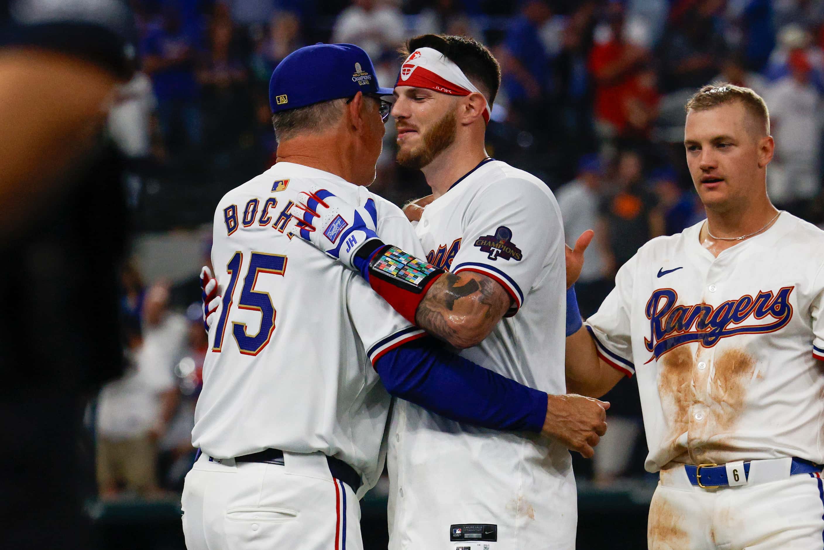 Texas Rangers catcher Jonah Heim (28) hugs manager Bruce Bochy after the game-winning hit...