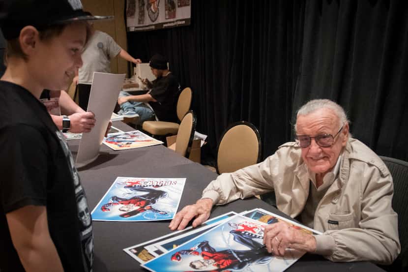 Stan Lee pauses while signing an autograph for Presley Caroll at the Marvelous Nerd Year's...