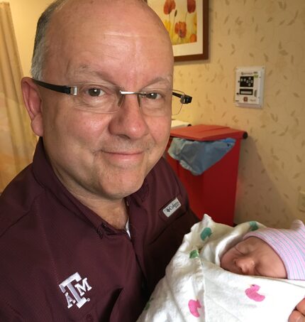 Walter Wilcox holding one of his grandchildren.