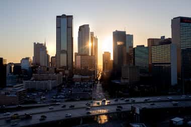 The sun sets behind the downtown Dallas skyline.  (Lynda M. Gonzalez/The Dallas Morning News)