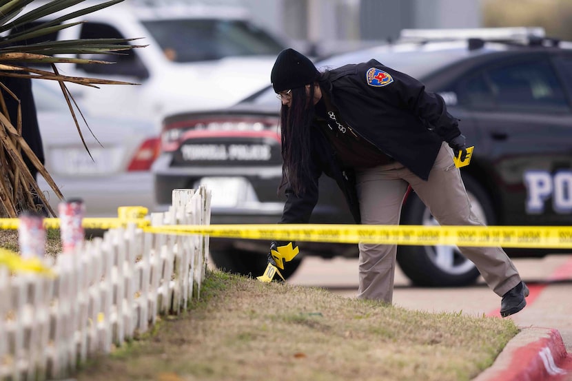 Evidence markers mark the scene as Kaufman County Sheriff investigate where Terrell police...