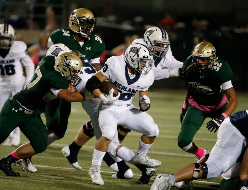 Richland's Rylee Johnson (20) runs against  Birdville during their UIL high school football...