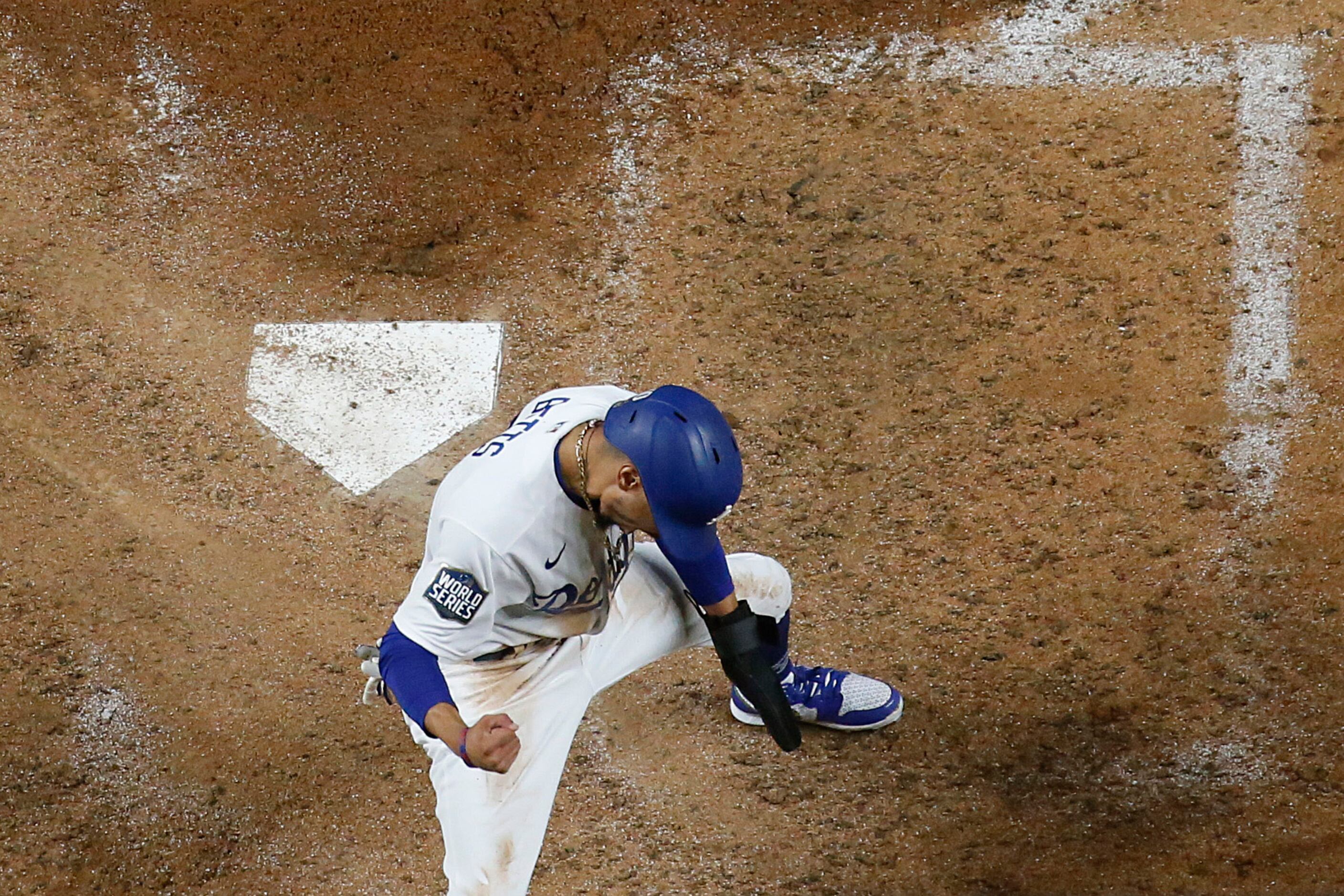 Los Angeles Dodgers right fielder Mookie Betts celebrates after scoring past Tampa Bay Rays...
