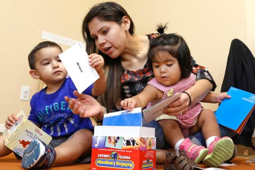 
Elizabeth Mancilla, a teacher at ChildCareGroup in Oak Cliff, helps Martin Correa, 2
1/2...