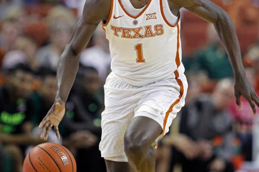 FILE - In this March 4, 2017, file photo, Texas guard Andrew Jones dribbles the ball during...