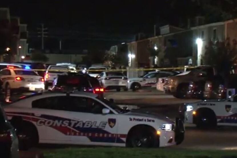 Several Harris County law enforcement vehicles gathered at an apartment complex in Houston...