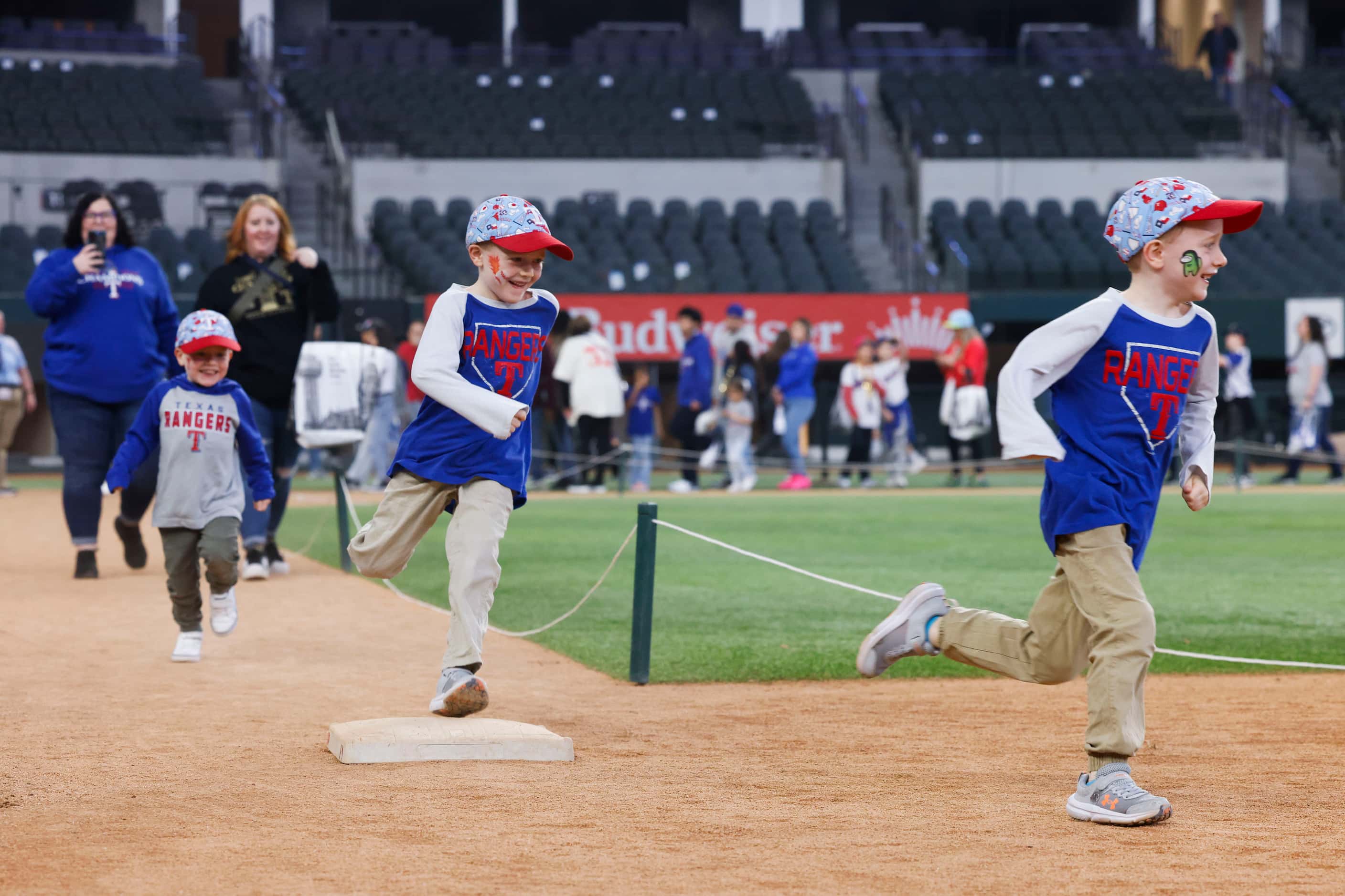 Caleb Dunlap 4, (left), his brothers, Logan, 6, (center), and Charlie, 6, runs through the...