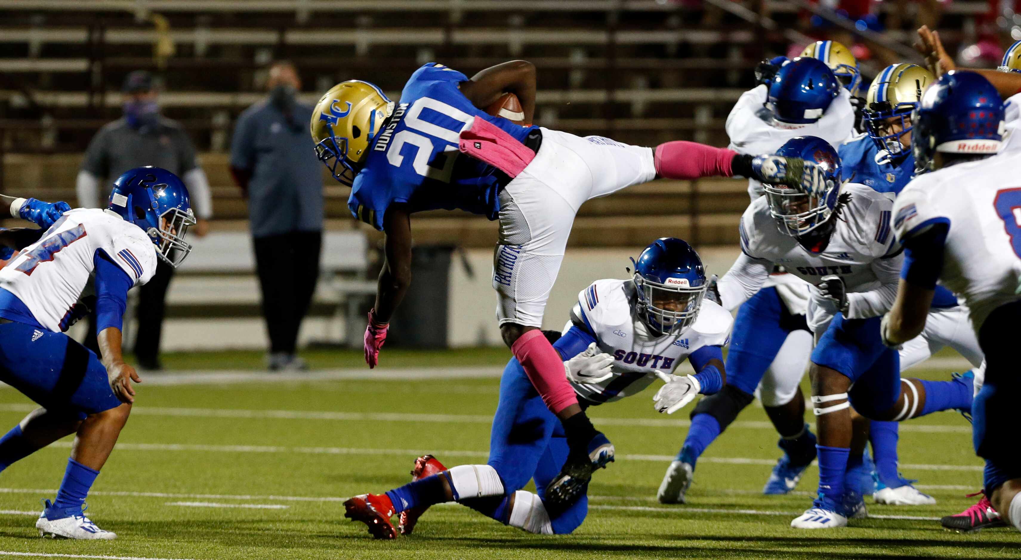 Lakeview Centennial RB Zechariah Dunston (20) goes flying through the South Garland defense...