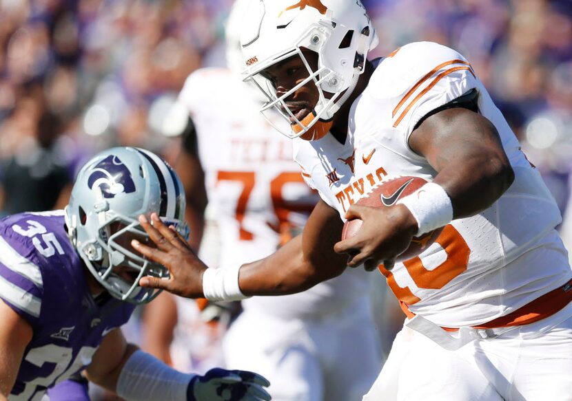 Texas quarterback Tyrone Swoopes (18) brushes aside Kansas State linebacker Will Davis (35)...