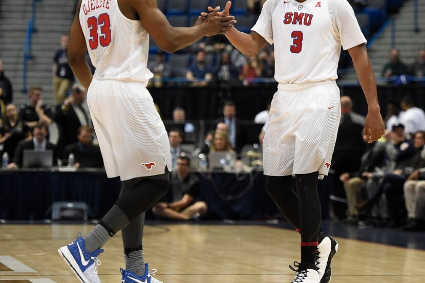 SMUâs Semi Ojeleye, left, and Sterling Brown slap hands at the end of an NCAA college...