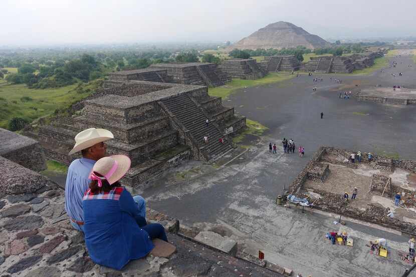 In this July 27, 2016 photo,tourists sit at the midway point of the Pyramid of The Moon...