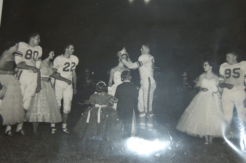 The football hero crowning the Homecoming queen