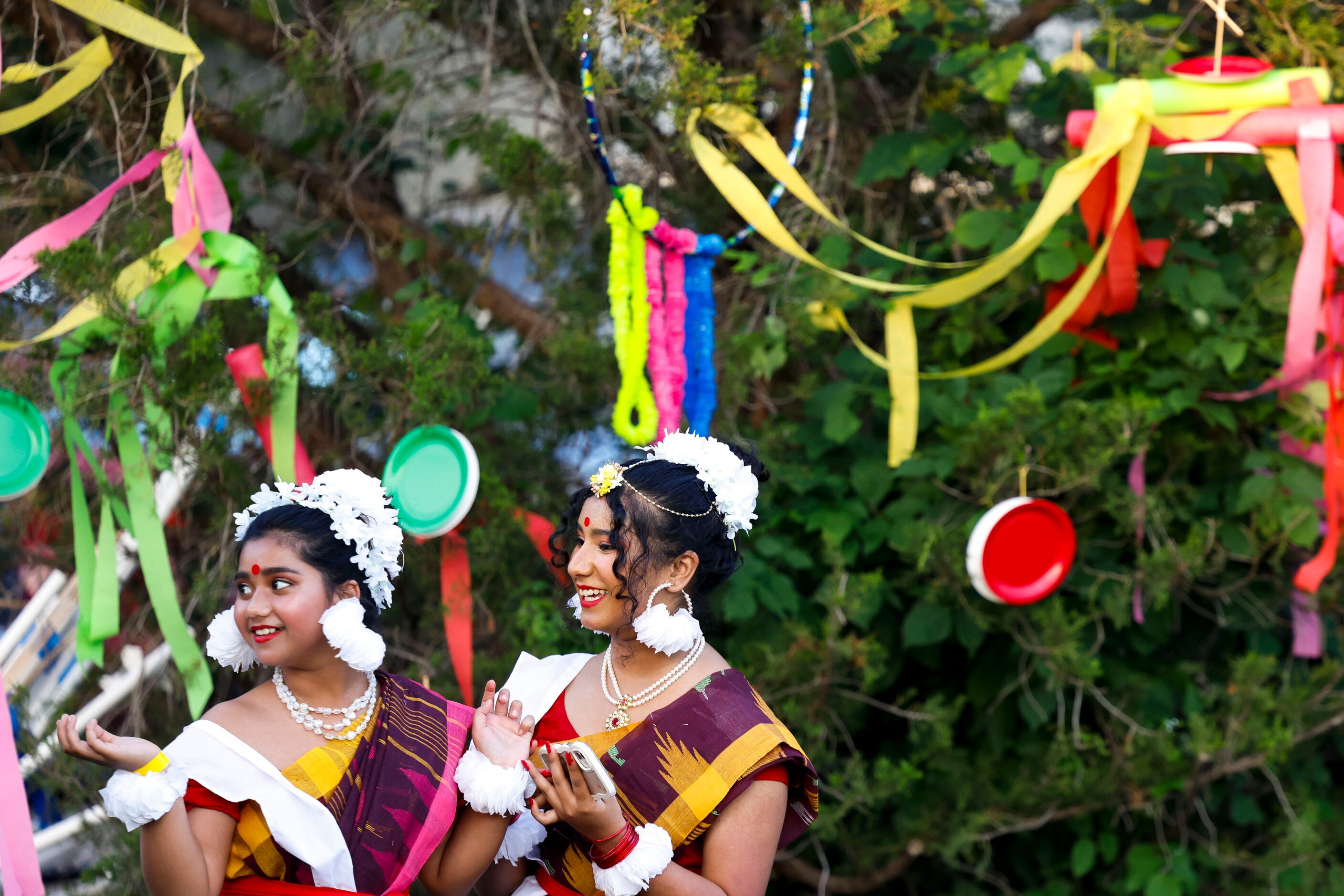 Shaifa Islam (left) and Mredula Hossain wait ahead of their performance during a Boishakhi...