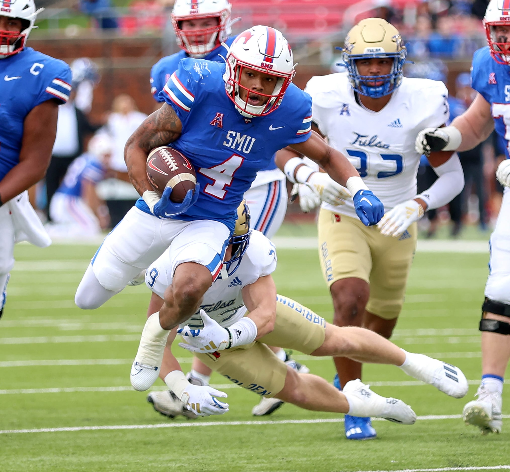 SMU running back Jaylan Knighton (4) finds a nice hole to run against Tulsa during the first...