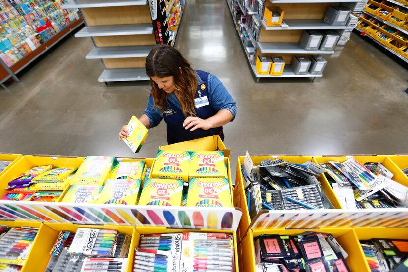 Valarie Alaniz (left) organizes school supplies at Walmart at Timber Creek Crossing in...