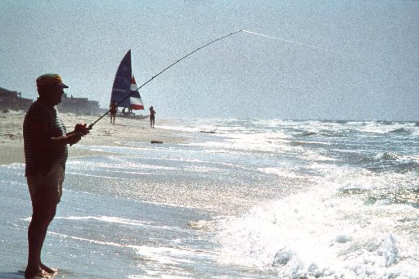 A man fishes off the beach at Gulf Shores, Ala., in this undated handout photo. Tourism...