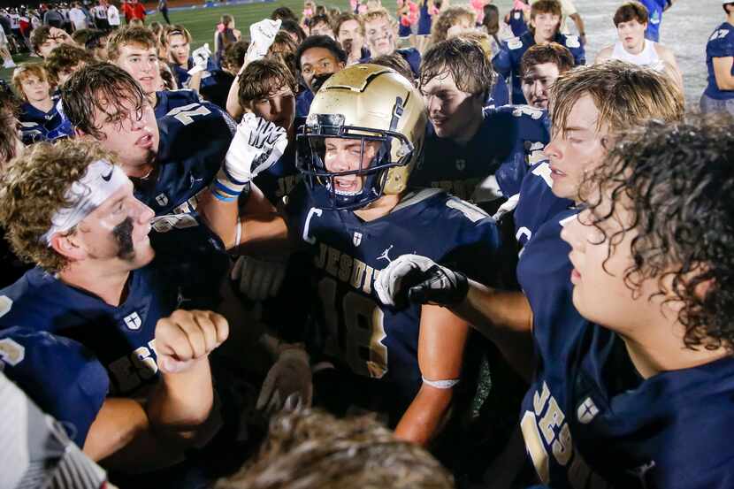 Jesuit senior running back Robert Fitzgerald, center, and his teammates celebrate a 48-45...