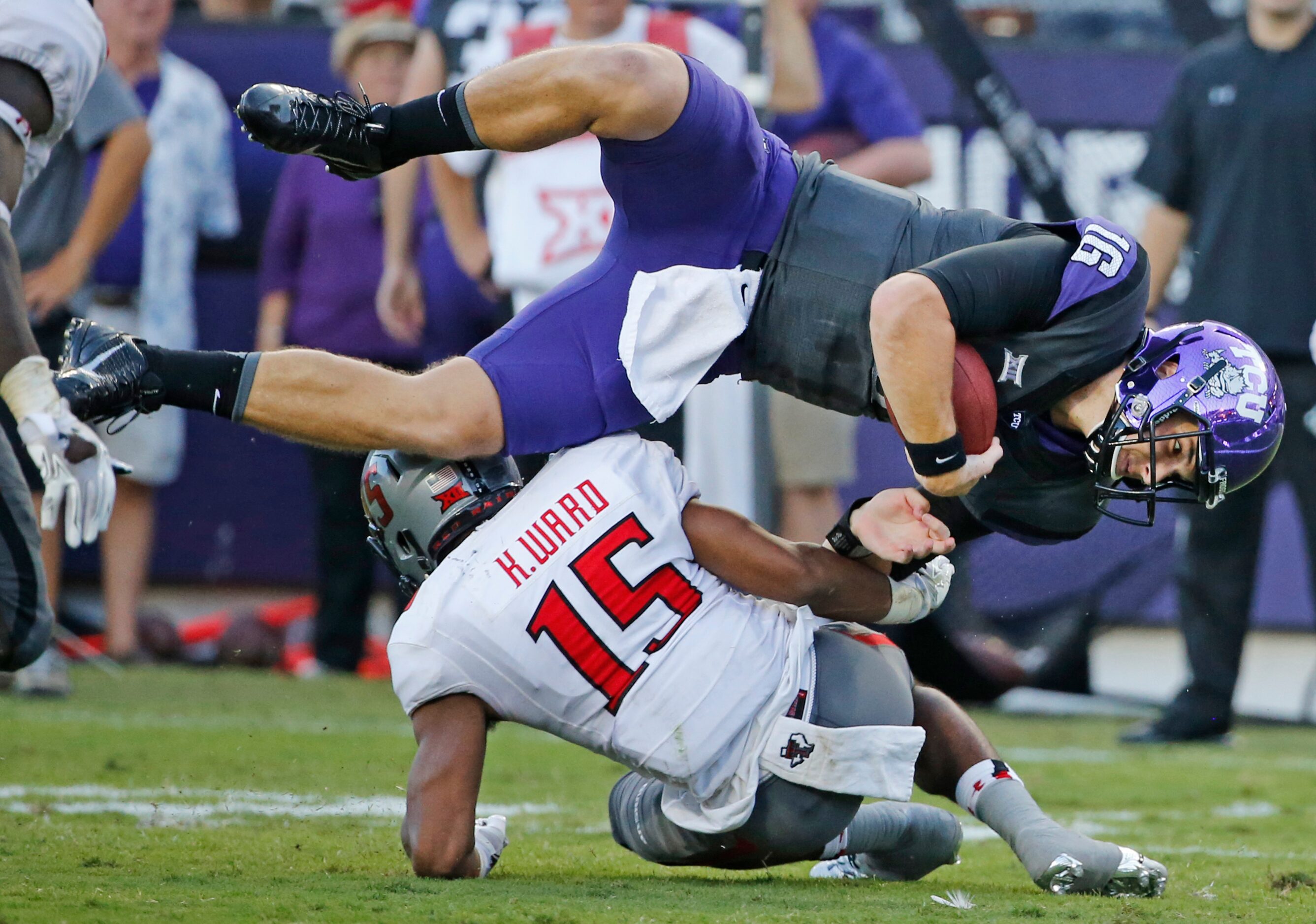 TCU quarterback Matt Joeckel (16) is upended by Texas Tech defensive back Keenon Ward (15)...