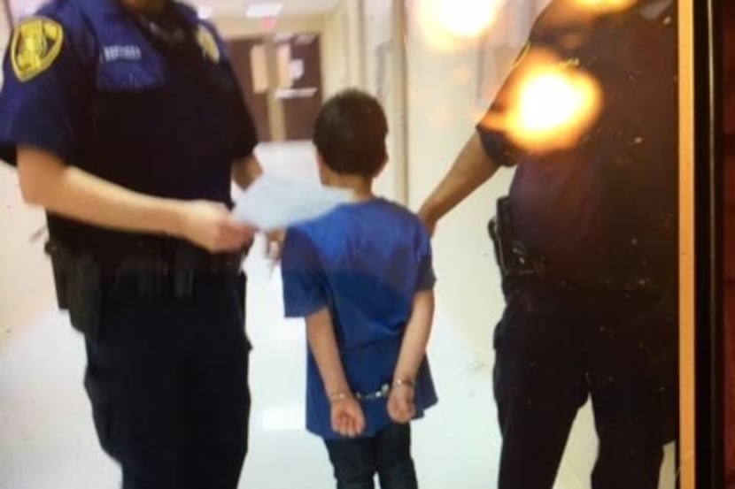A student at Gabe P. Allen Charter School is handcuffed.